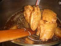 Taking the Chicken Wings out of the Fryer Picture